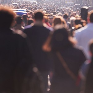 Perspective photo of a sea of people walking up and down a street